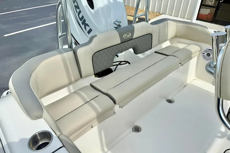 Slide: The Image of 2025 Key West 203 FS boat interior with beige seating and Suzuki engine. - 23