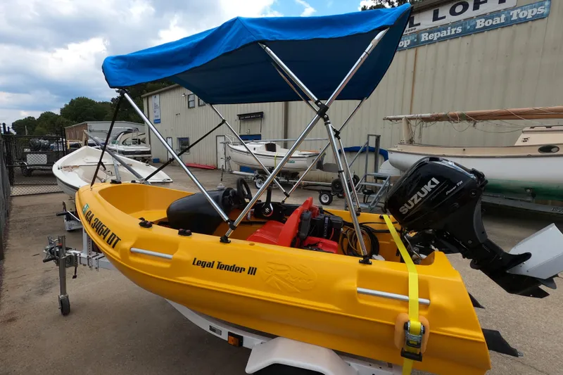 Slide: The Image of 2022 River Boats 290XR with Suzuki motor, yellow hull, blue canopy, docked at marina. - 3