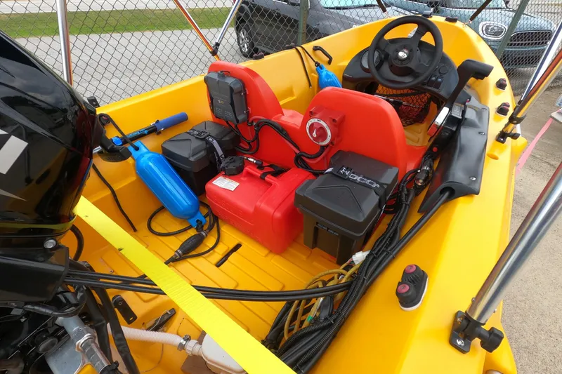 Slide: The Image of Yellow 2022 River Boats 290XR interior with steering wheel, red seats, and equipment. - 5