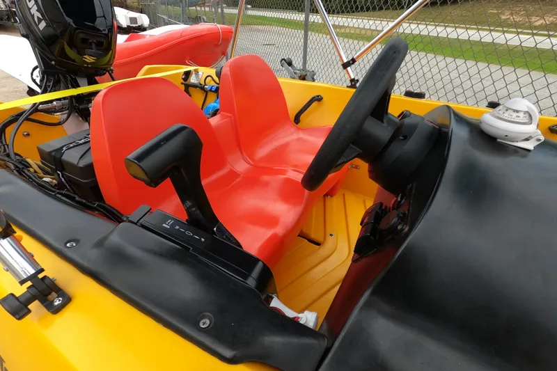 Slide: The Image of Interior of 2022 River Boats 290XR with red seats and steering wheel. - 9