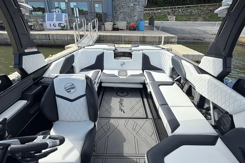 Slide: The Image of 2023 Tigé 24RZX boat interior with luxurious seating and modern design at a dock. - 10