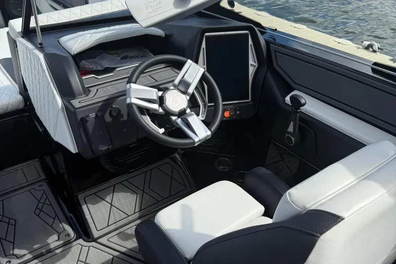Slide: The Image of 2023 Tigé 24RZX boat interior with modern steering wheel and touchscreen display. - 12