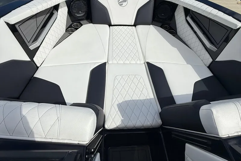 Slide: The Image of 2023 Tigé 24RZX boat interior with white and black diamond-stitched upholstery. - 13