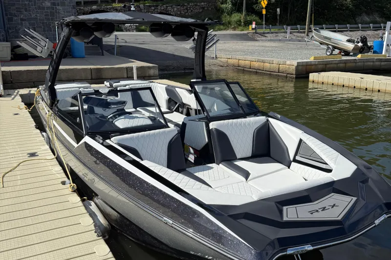 Slide: The Image of 2023 Tigé 24RZX boat docked, featuring sleek design and luxurious seating. - 3