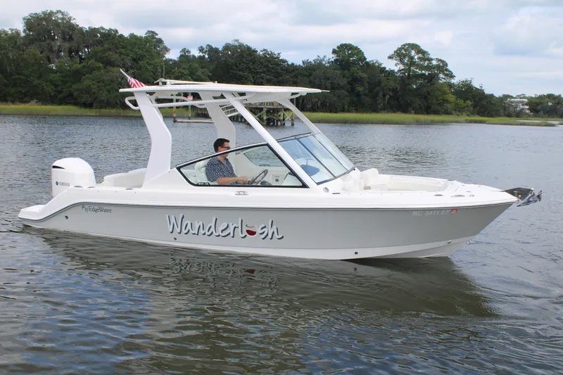 The Image of 2020 Edgewater 230 CX boat named "Wanderlush" cruising on a calm river. - 0