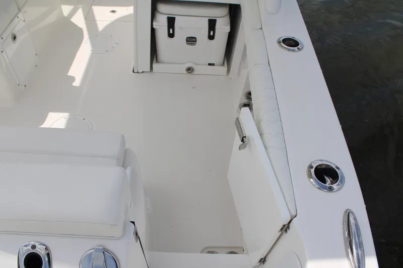 Slide: The Image of 2020 Edgewater 230 CX boat interior with seating and storage compartments. - 18