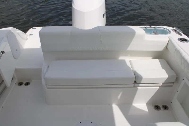 Slide: The Image of 2020 Edgewater 230 CX boat interior with white cushioned seating and water view. - 21