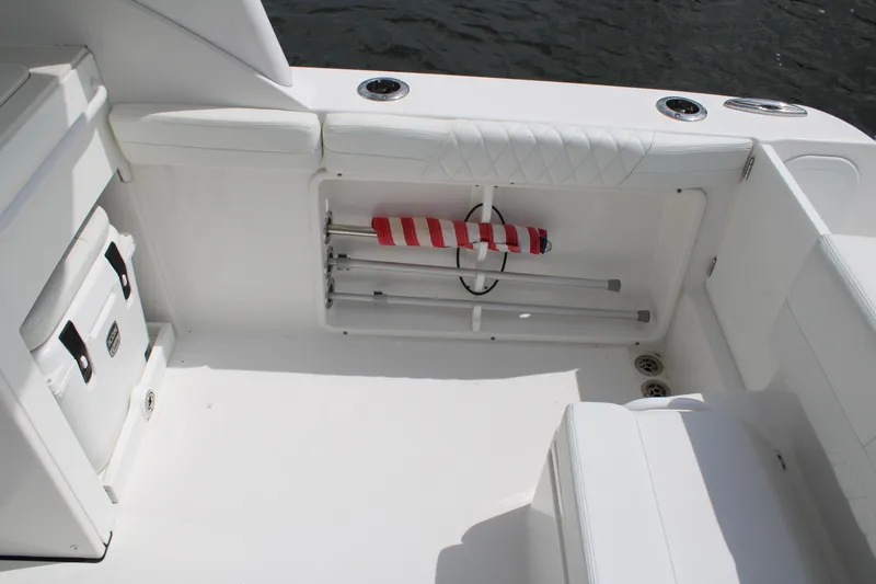 Slide: The Image of 2020 Edgewater 230 CX boat interior with storage compartment and seating. - 26