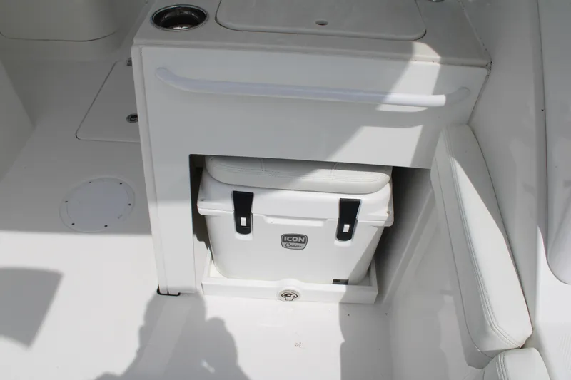 Slide: The Image of Edgewater 230 CX 2020 boat interior with built-in cooler storage compartment. - 27