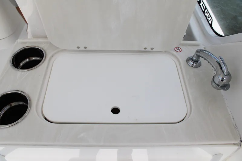 Slide: The Image of Edgewater 230 CX 2020 boat sink with faucet and cup holders. - 30