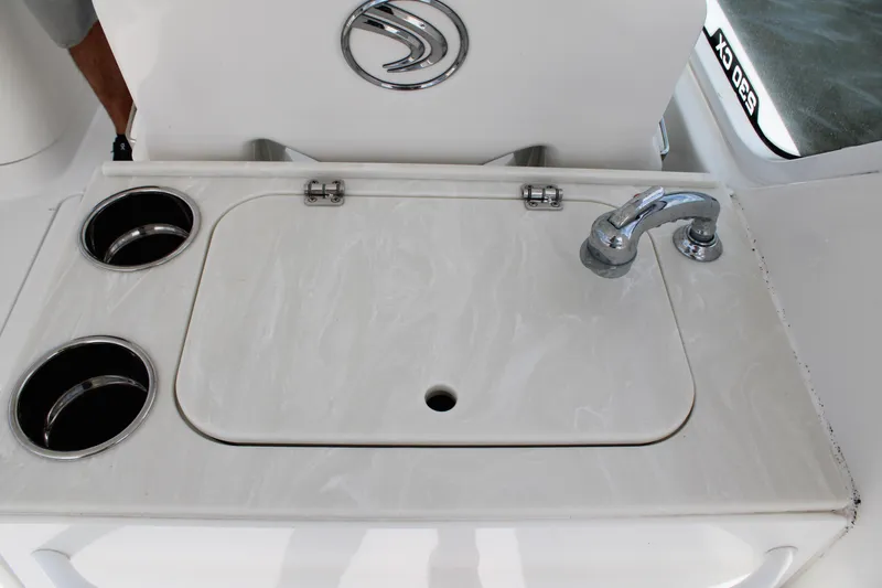 Slide: The Image of Edgewater 230 CX 2020 boat sink with cup holders and faucet. - 31