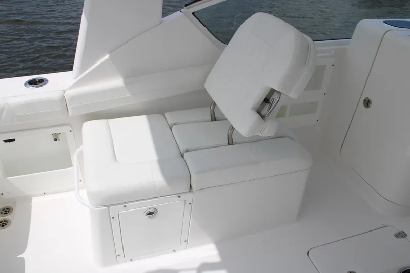 Slide: The Image of White seating area on 2020 Edgewater 230 CX boat, featuring adjustable backrest and storage compartment. - 32