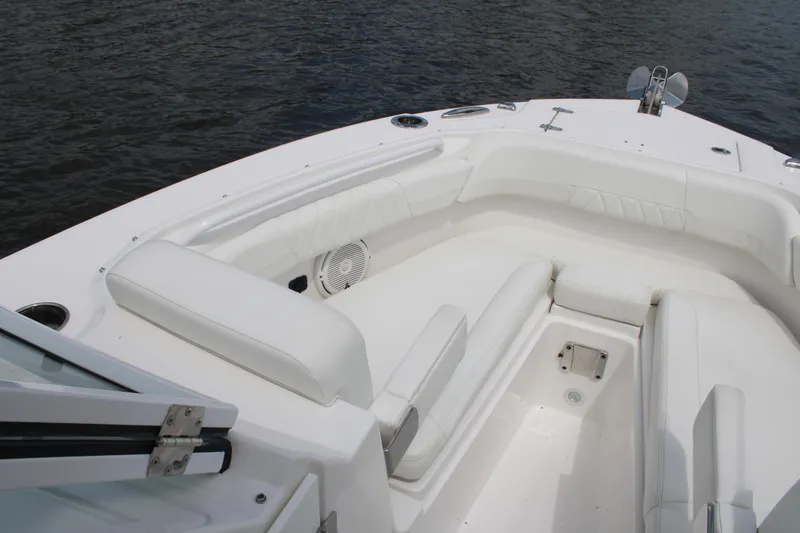 Slide: The Image of 2020 Edgewater 230 CX boat interior with white seating and water view. - 43