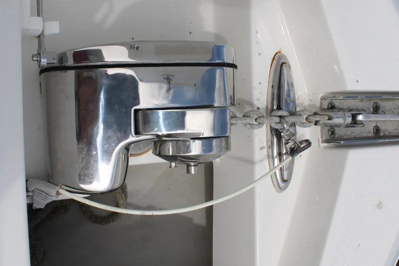 Slide: The Image of Anchor windlass on 2020 Edgewater 230 CX boat, featuring a polished metal finish. - 46