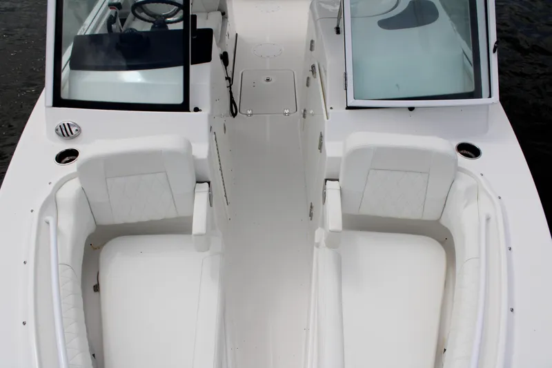 Slide: The Image of 2020 Edgewater 230 CX boat interior with white seating and open windshield. - 49
