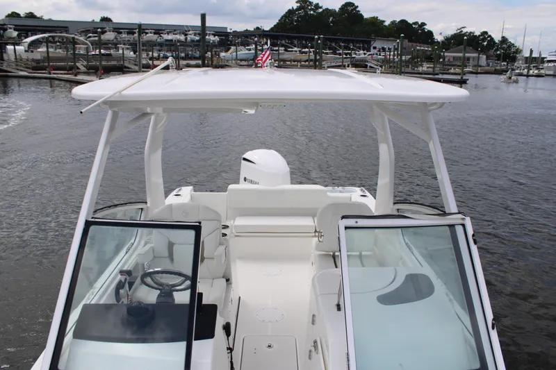 Slide: The Image of 2020 Edgewater 230 CX boat with open cockpit, docked at marina. - 51