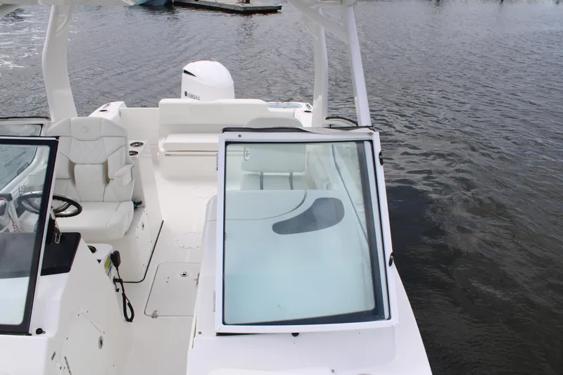 Slide: The Image of Edgewater 230 CX 2020 boat interior with seating and windshield on water. - 53