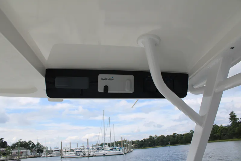 Slide: The Image of Edgewater 230 CX 2020 boat with Garmin equipment, docked at marina under cloudy sky. - 58
