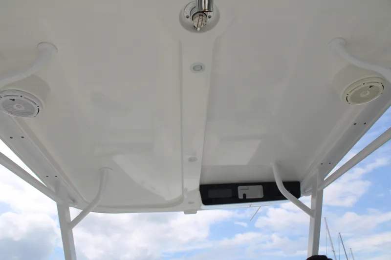 Slide: The Image of 2020 Edgewater 230 CX boat roof with speakers and clear sky background. - 59