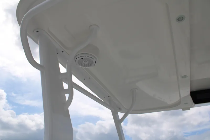 Slide: The Image of 2020 Edgewater 230 CX boat canopy with integrated speaker, under a cloudy sky. - 60