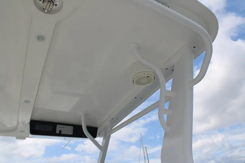 Slide: The Image of 2020 Edgewater 230 CX boat canopy with integrated speaker and lighting against a cloudy sky. - 61
