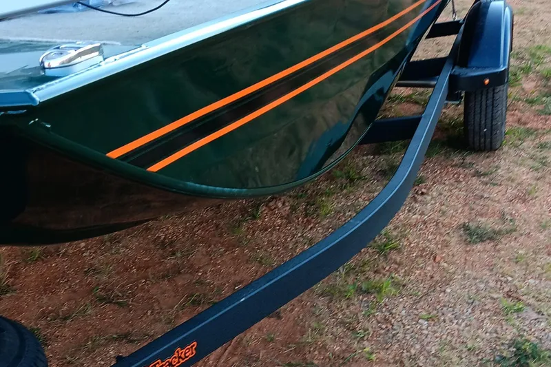 Slide: The Image of 2026 Tracker Bass Tracker Classic Limited boat on trailer, green with orange stripes. - 13