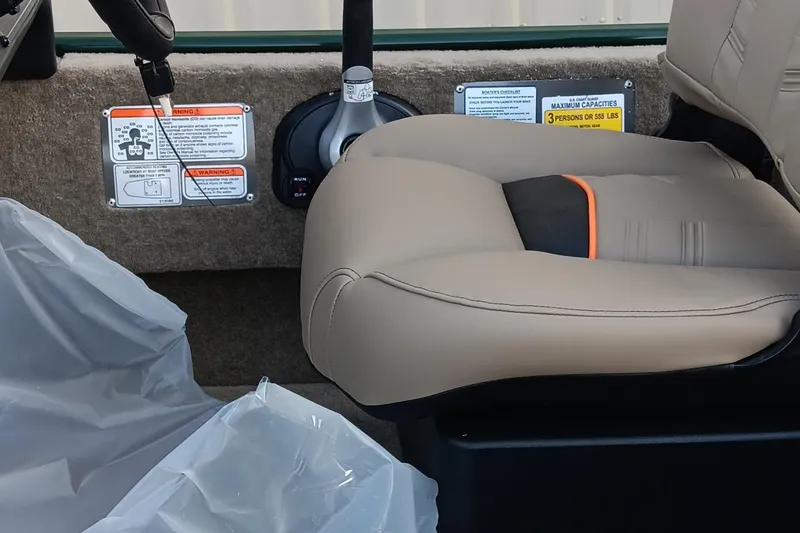 Slide: The Image of Interior of 2026 Tracker Bass Tracker Classic Limited boat with beige seating and control panel. - 14