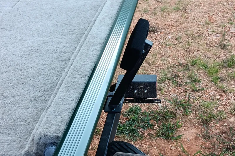 Slide: The Image of 2026 Tracker Bass Tracker Classic Limited boat trailer detail on gravel surface. - 15