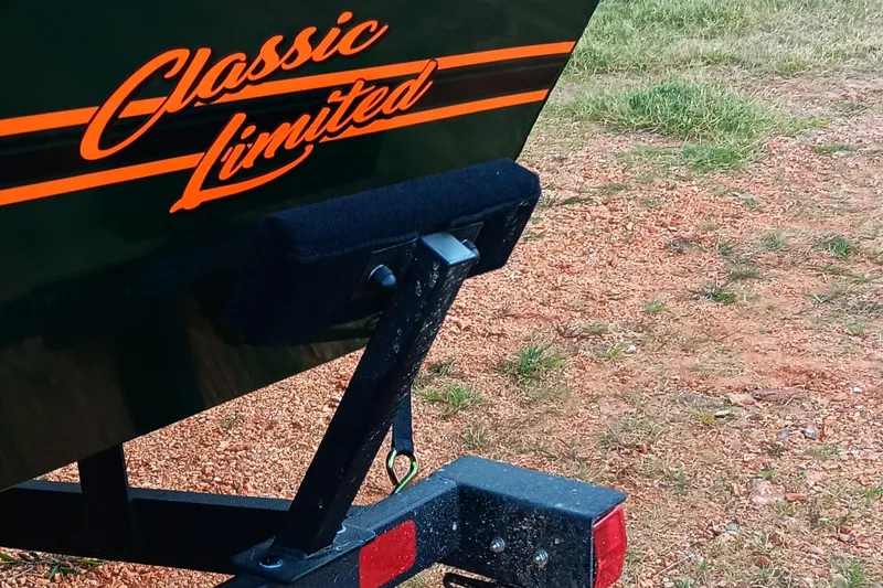 Slide: The Image of 2026 Tracker Bass Tracker Classic Limited boat trailer on gravel. - 16