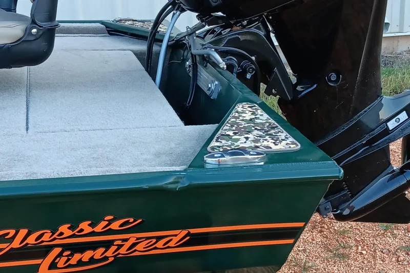 Slide: The Image of 2026 Tracker Bass Tracker Classic Limited boat with camouflage accents and motor detail. - 18