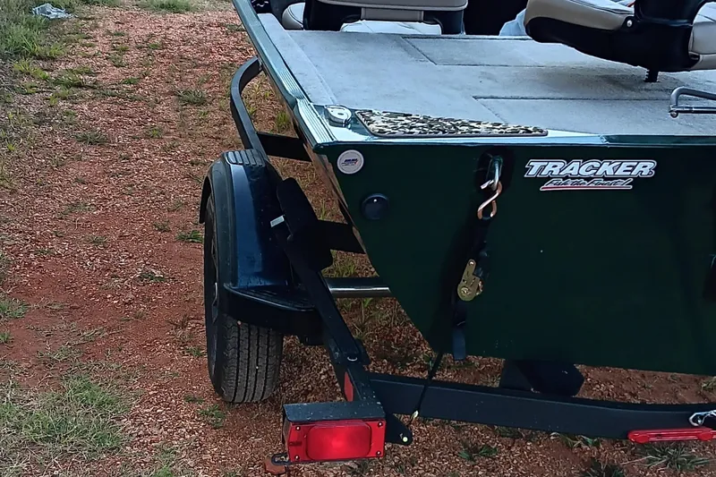 Slide: The Image of 2026 Tracker Bass Tracker Classic Limited boat on a trailer, parked on gravel. - 2