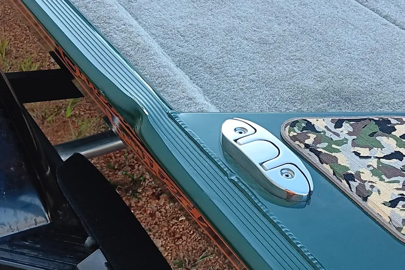 Slide: The Image of 2026 Tracker Bass Tracker Classic Limited boat detail with camo pattern and metal cleat. - 3