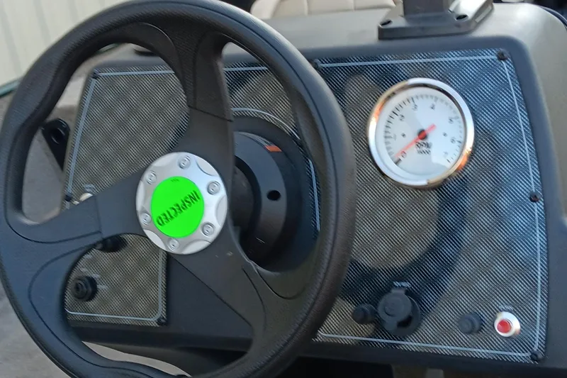 Slide: The Image of 2026 Tracker Bass Tracker Classic Limited dashboard with steering wheel and gauge. - 7