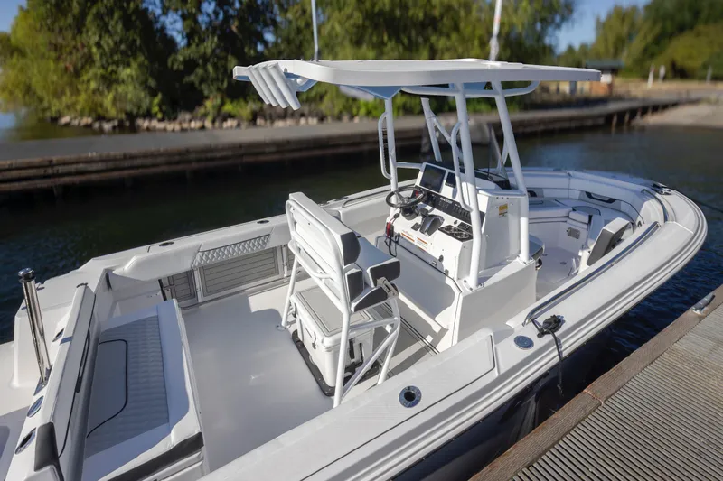 Slide: The Image of 2024 Blackfin 222 CC boat docked, featuring a sleek design and modern console. - 11