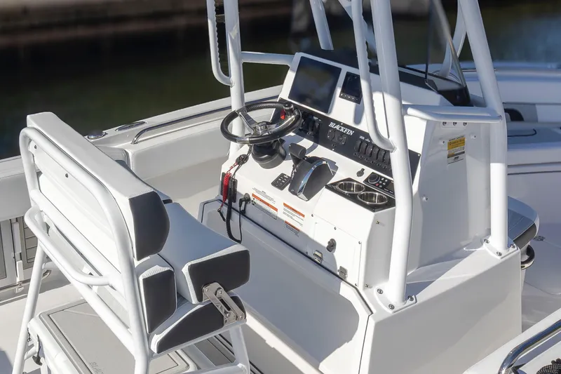 Slide: The Image of 2024 Blackfin 222 CC boat console with steering wheel and controls. - 21