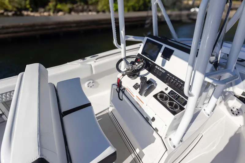 Slide: The Image of 2024 Blackfin 222 CC boat cockpit with modern controls and seating. - 22