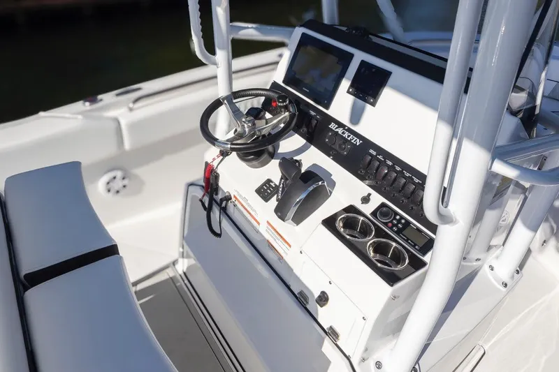 Slide: The Image of 2024 Blackfin 222 CC boat console with steering wheel and controls. - 23