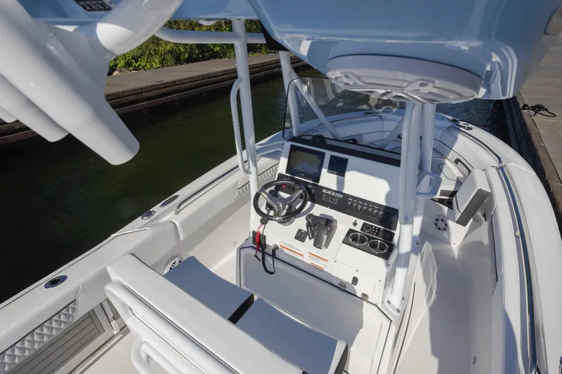Slide: The Image of 2024 Blackfin 222 CC boat interior with modern console and seating. - 25