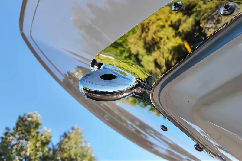 Slide: The Image of 2024 Blackfin 222 CC boat detail with polished metal against blue sky. - 27
