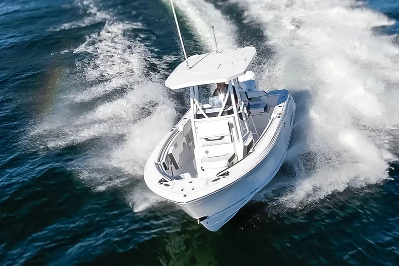 Slide: The Image of 2024 Blackfin 222 CC boat cruising swiftly on open water. - 3