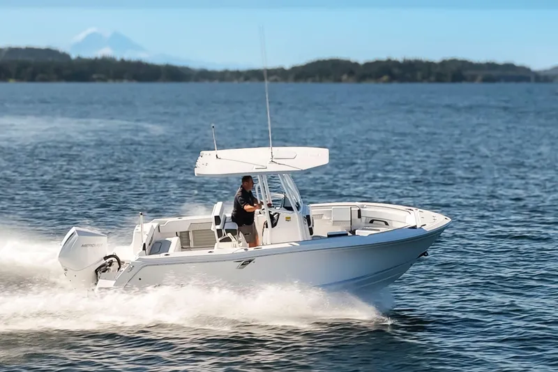 Slide: The Image of 2024 Blackfin 222 CC boat cruising on open water under clear blue skies. - 5