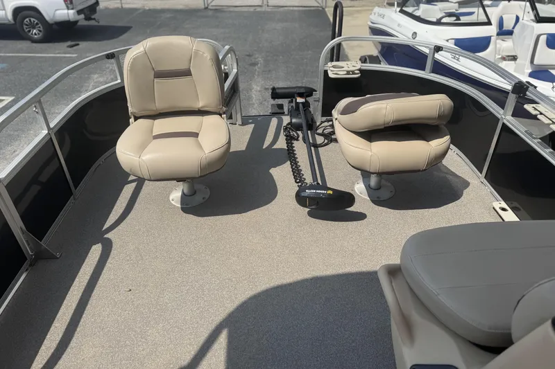 Slide: The Image of 2017 Sun Tracker Bass Buggy 18 DLX pontoon boat interior with beige seating. - 10