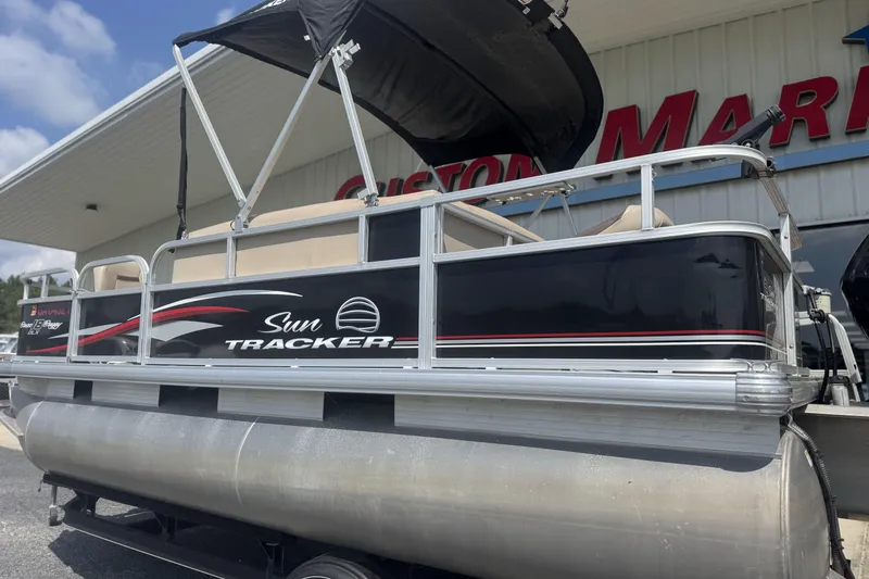 Slide: The Image of 2017 Sun Tracker Bass Buggy 18 DLX pontoon boat at marina, side view. - 8
