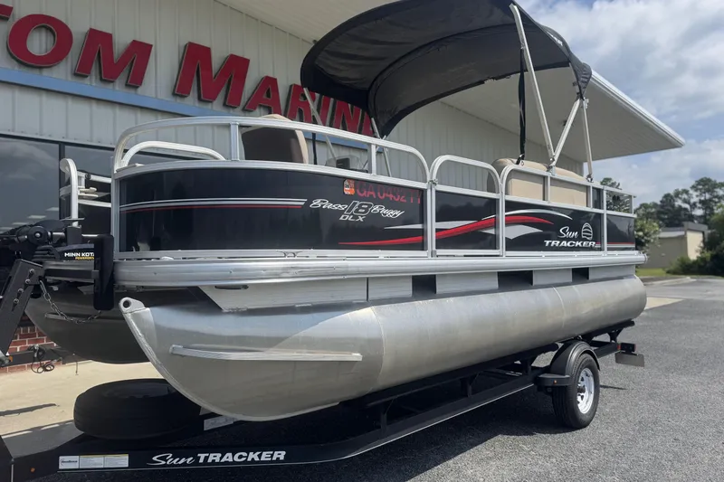 Slide: The Image of 2017 Sun Tracker Bass Buggy 18 DLX pontoon boat on trailer, outdoor display. - 9