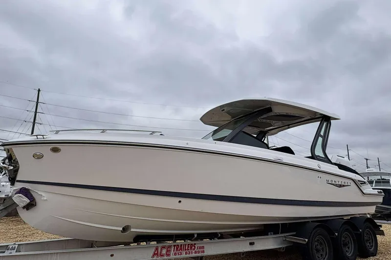 The Image of 2026 Monterey 27 Elite boat on trailer under cloudy sky. - 1