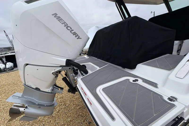 Slide: The Image of 2026 Monterey 27 Elite boat with Mercury outboard engine, featuring sleek deck design. - 14