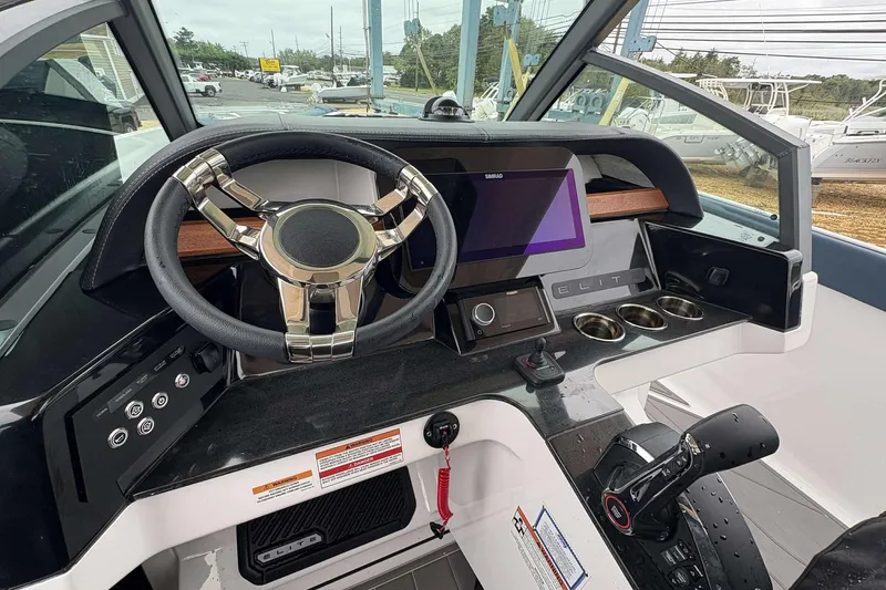 Slide: The Image of 2026 Monterey 27 Elite boat dashboard with modern steering wheel and digital display. - 6