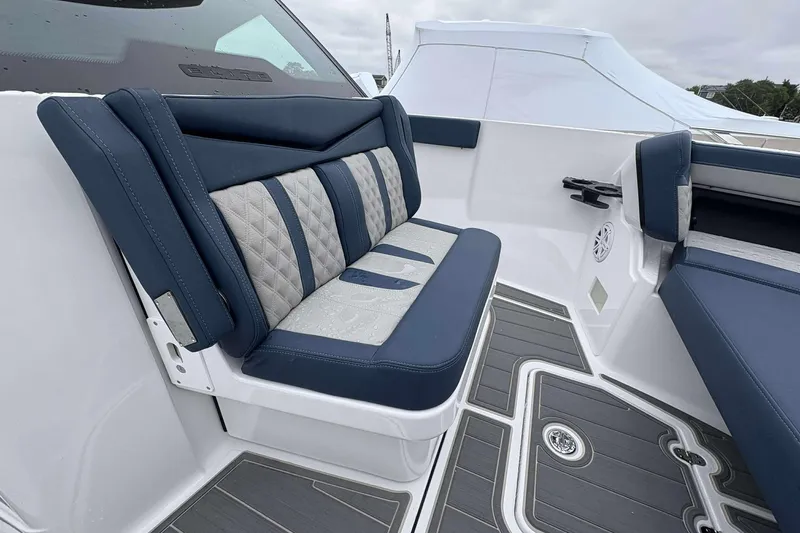 Slide: The Image of Luxurious seating on 2026 Monterey 27 Elite boat, featuring blue and gray upholstery. - 7