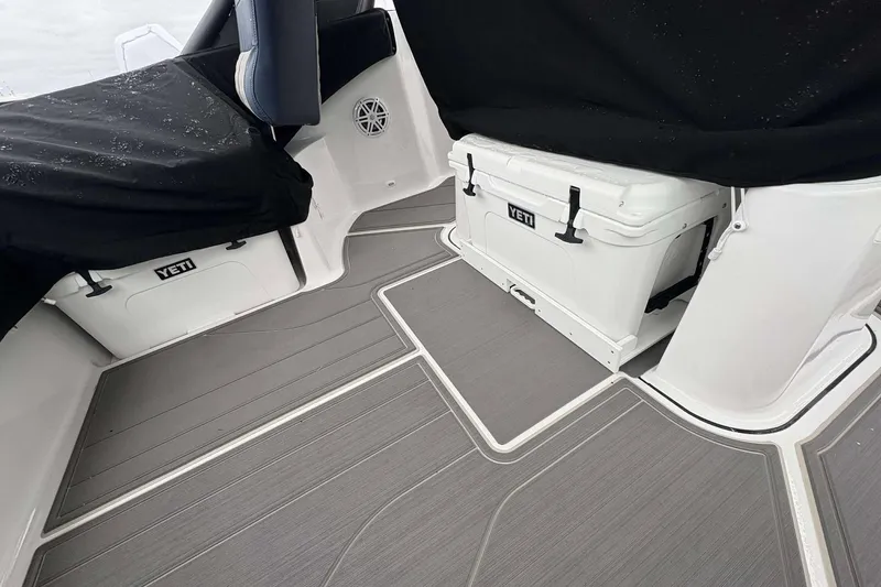 Slide: The Image of Interior of 2026 Monterey 27 Elite boat with Yeti coolers and sleek flooring. - 9