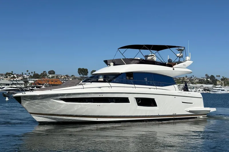 The Image of 2016 Prestige 500 yacht cruising in a scenic harbor setting. - 0